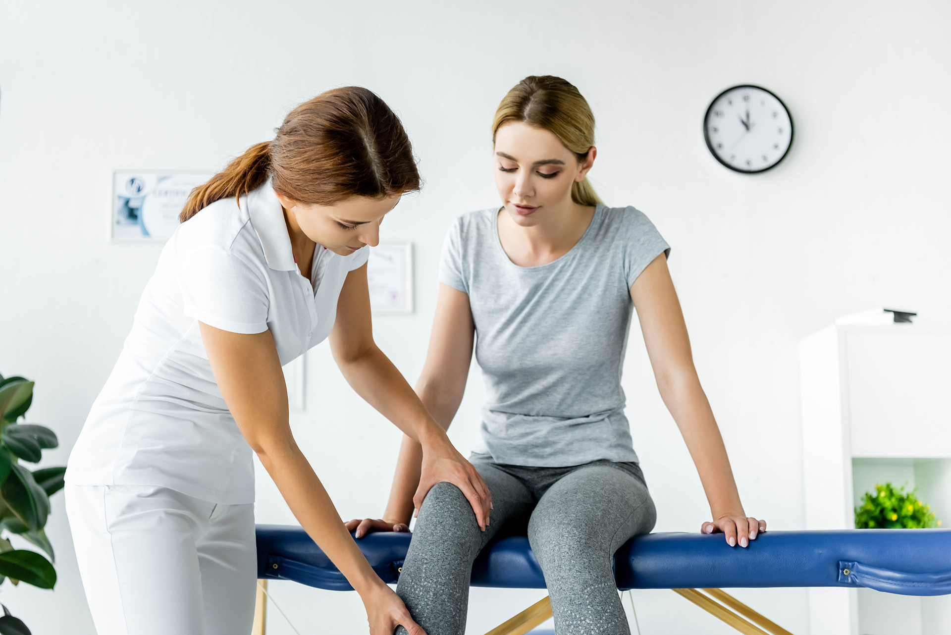 Skilled St. Albert Chiropractor evaluating a patient that's sitting on their table