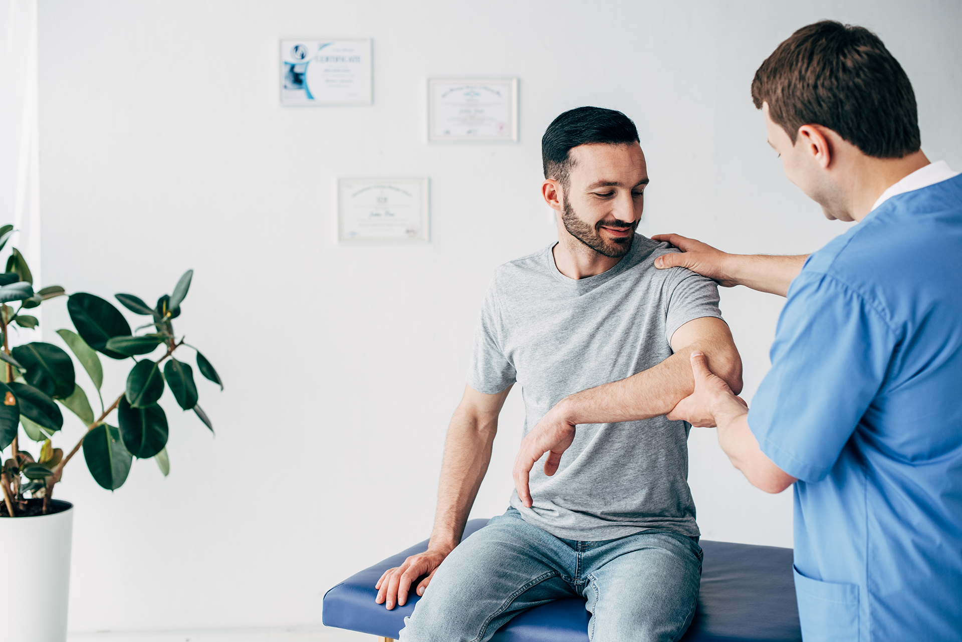 Trusted Chiropractor adjusting patient's shoulder